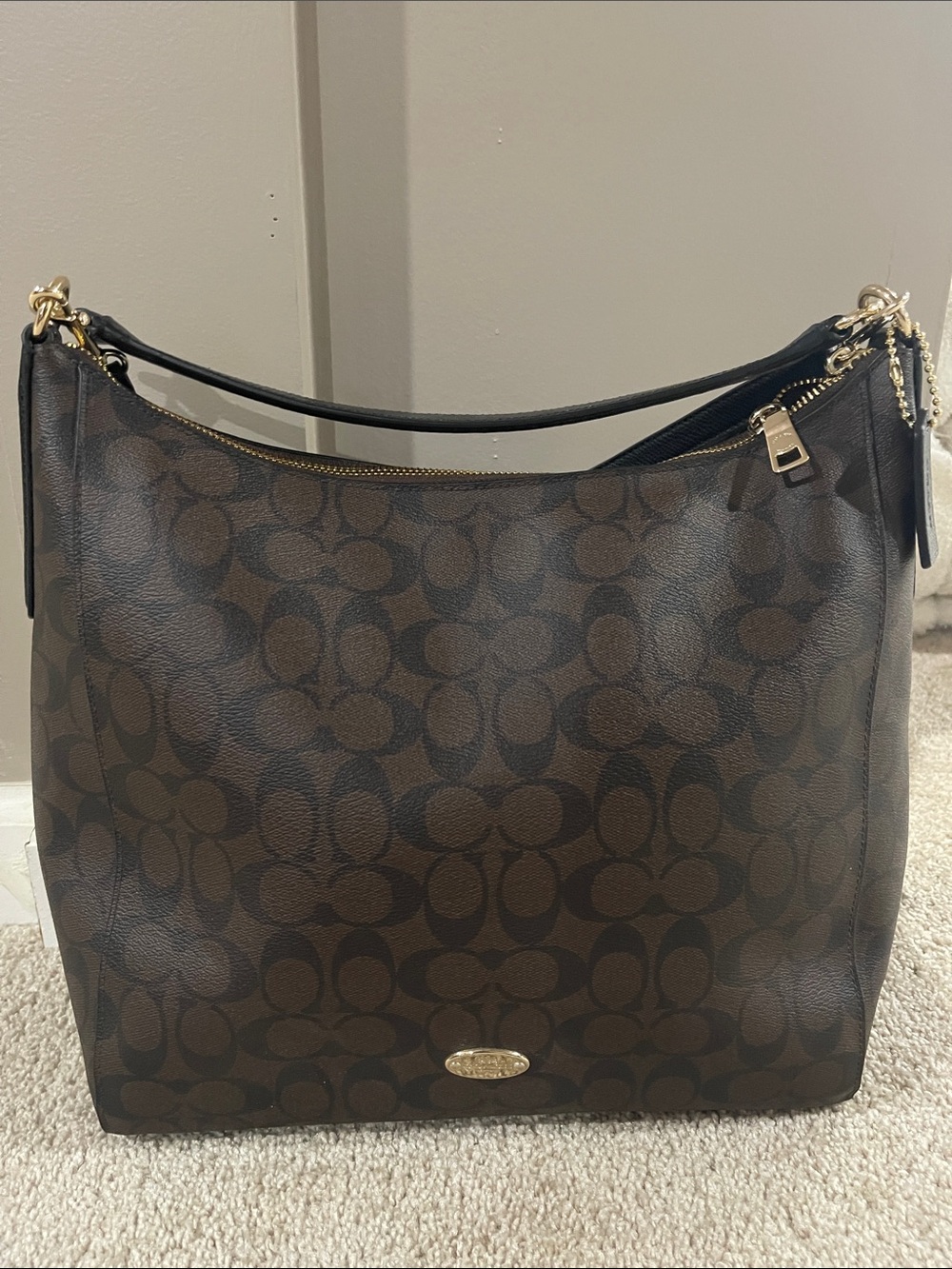 Coach Brown Signature Canvas Shoulder Bag with Black Strap
Size: 34w 33h